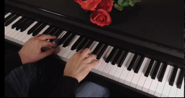 About us: Hands playing piano with roses